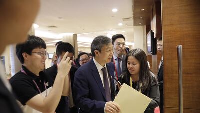 Yi Gang, governor of the People's Bank of China (PBOC), centre, has given more insight into plans to open the country's financial sector. Qilai Shen/Bloomberg