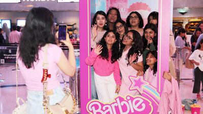 The Barbie movie is now showing in the UAE. Pictured: Barbie fans taking their photos at the interactive Barbie display at Vox cinema at Mall of the Emirates in Dubai. All photos: Pawan Singh / The National