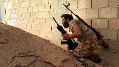 A member of forces loyal to Libya's eastern government carries his weapon during clashes with the Shura Council of Libyan Revolutionaries in Benghazi. Reuters