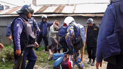 Bangladeshi police beat a suspect following an attack on a polling station in the northern town of Bogra on Sunday. AFP