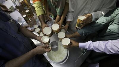 A man serves refreshments for Pakistan Independence Day.