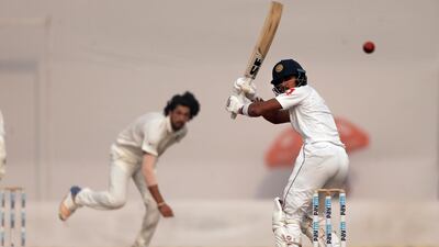 Dinesh Chandimal, right, plays and misses during Day 3 of the third and final Test between India and Sri Lanka. Altaf Qadri / AP Photo
