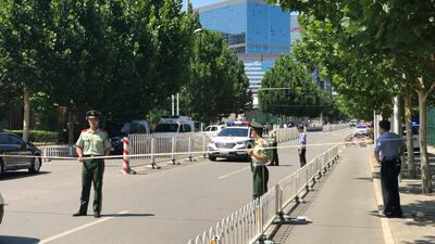 Chinese media report witnesses describing a man attempting to throw a homemade bomb into the embassy. AP Photo