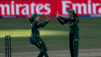 Pakistan's Omaima Sohail, right, celebrates the wicket of India's Shafali Verma with captain Fatima Sana. AP