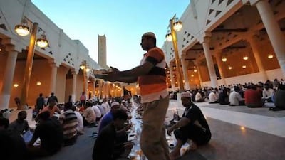 Foreign workers prepare to break their fast outside the Imam Turki bin Abdullah mosque in the Saudi capital Riyadh during Islam's holy month of Ramadan last year.