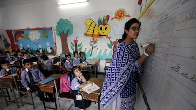 A school teacher instructs children at a school. Accountability in education may be a double-edged sword. Bilawal Arbab/EPA