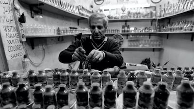 Razy Mukarker, Palestine: Razy captures an artist crafting shapes of cities and names of buyers using coloured sand in the Palestinian city of Hebron.