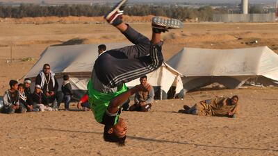 A Palestinian youth practices his parkour skills at the Israel-Gaza border in the southern Gaza Strip. Mohammed Salem / Reuters