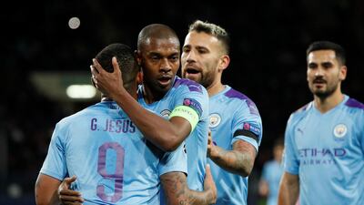Fernandinho, centre, is training at home in Brazil with some help from his two children. Reuters