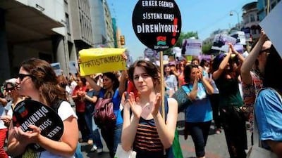 A Turkish woman holds a placard that translates as "No men-dominant system" during a large pro-abortion protest in Istanbul on Sunday.