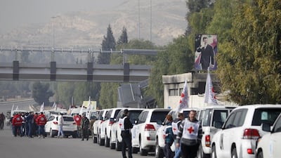 An aid convoy consisting of Red Cross, Red Crescent and UN vehicles comes together before delivering food and medical supplies in Syria. Reuters