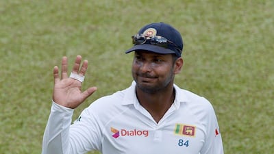 Sri Lanka's Kumar Sangakkara waves to suporters on Sunday, his final innings of Test cricket, as his side chased India in Colombo. Ishara S Kodikara / AFP / August 23, 2015