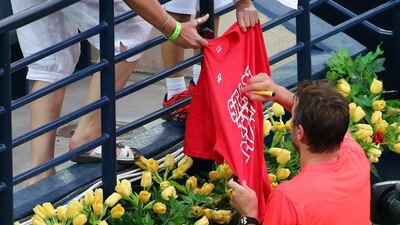 Stanislas Wawrinka of Switzerland signs autographs as he leaves the court after winning his ATP semi-final of the Dubai Duty Free Tennis Championship against Nick Kyrgios of Australia on February 26, 2016. Wawrinka won the match as Kyrgios, battling back pain, was forced to abandon in the second set. / AFP / MARWAN NAAMANI