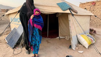 Seven-year-old Mina (name changed) and her mother Qamar Gul outside their shelter, a makeshift house, in Shaidahi area on the outskirts of Herat city. Hikmat Noori for The National