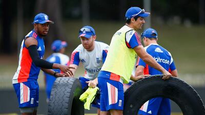 Alastair Cook, Chris Jordan and Jonny Bairstow help in removing tyres used during the training session.