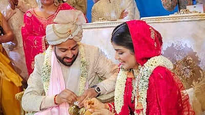 The bride wore a red legenga, and the groom wore a light pink sherwani and a bejewelled turban