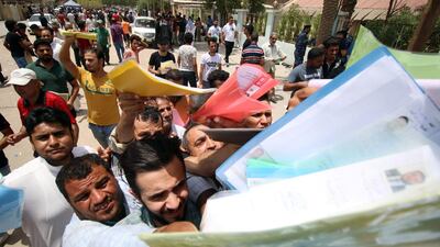 Iraqi protesters hand over job requests to government employees in Basra. Reuters