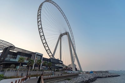 Tourists look out across the water in the shadow of Ain Dubai at Bluewaters Island. Chris Whiteoak / The National