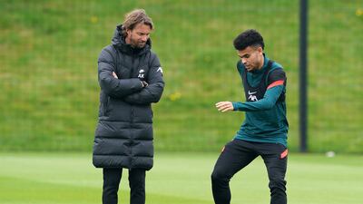 Liverpool's Luis Diaz, right, and fitness coach Andreas Kornmayer during a training session at the AXA Training Centre. PA