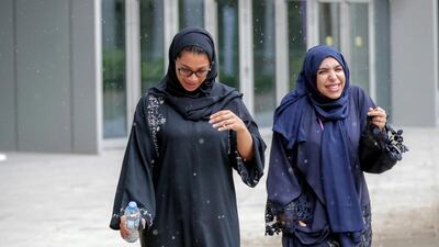 People rush for shelter from the rain at NYU Abu Dhabi. Victor Besa/The National