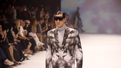 A male model walks the runway during the Michael Cinco show at Arab Fashion Week in Dubai.
