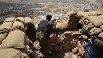 In this photo from June 19, 2016, a Lebanese soldier takes his position overlooking an area controlled by ISIL on the edge of the town of Arsal in north-east Lebanon. Hussein Malla, File / AP