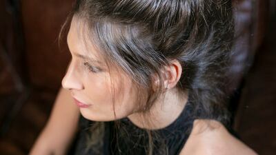 A messy bun is an attractive way to style unstraightened hair. Photo: Rossano Ferretti