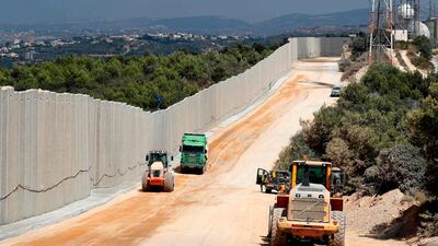 Near the Rosh Hanikra border crossing in northern Israel, shows tractors along a new wall on the Israeli-Lebanese border. AFP