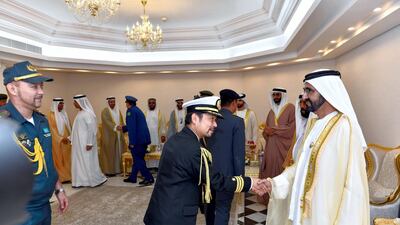 Sheikh Mohammed bin Rashid, Vice President, Ruler of Dubai and Minister of Defence, is greeted by officials at the Khalifa bin Zayed Air College in Al Ain on Monday. Wam
