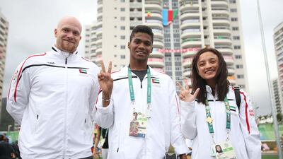 National swimming coach Eetu Karvonen with medal hopes Yaaqoub Al Saadi and Nada Al Bedwawi at the Olympic Village in Rio. Wam