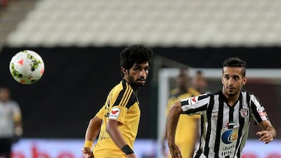 Ali Mabkhout, right, and Kalba’s Khaled Ali Khamis tussel for the ball. Ravindranath K / The National