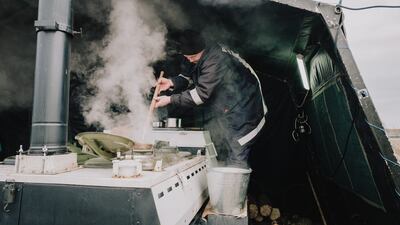 Officers from the Moldovan Ministry of the Interior prepare meals for those at the Palanca refugee camp.