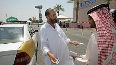 Mashahoor Afzal, a Pakistan taxi driver, asks Jaber al Braiki, not to give him a fine outside Marina Mall yesterday.