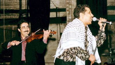 Palestinian-American violinist and oud player Simon Shaheen, left, supporting Khaled at New York's Beacon Theatre in 2002