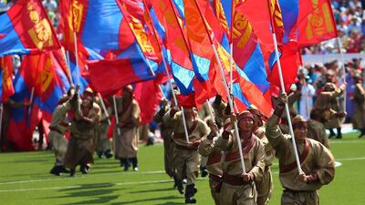 Mongolians in traditional attire hold national flags during the opening ceremony of the Naadam Festival in Ulan Bator, Mongolia. The annual Naadam Festival is the most important festival of the year and is a traditional Mongolian pageant for entertainment and games with horse racing, wrestling and archery - known as ‘the three games of men’. Wu Hong / EPA