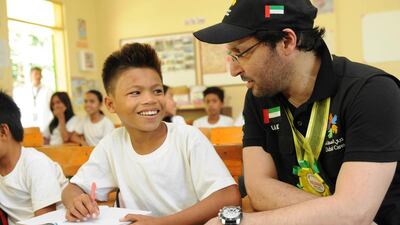 Dubai Cares CEO Tariq Al Gurg speaks to a student at one of the schools in the province of Masbate that benefited from the US$2 million Raise program, which aims to keep young, marginalized students, mostly girls, in school. Photo courtesy of Dubai Cares