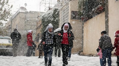 Temperatures dropped below zero in Damascus on Friday and heavy snow led to road closures on routes heading in to the city. Yousseff Badawi / EPA