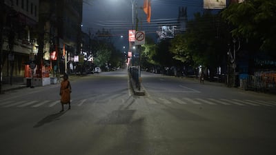 A woman walks along a deserted street during a government-imposed lockdown as a preventive measure against the spread of the Covid-19 coronavirus, in Siliguri on March 24, 2020. AFP