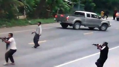 In this photograph taken from videotape footage, suspected separatist militants open fire with automatic weapons during an attack on Thai soldiers in Pattani on July 28. Four soldiers were killed and two others wounded.