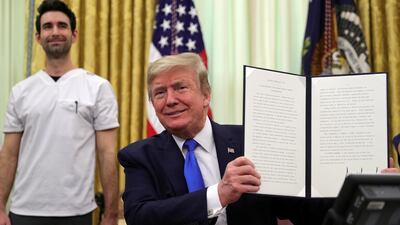 US President Donald Trump displays a proclamation in honour of National Nurses Day in the Oval Office at the White House. Reuters