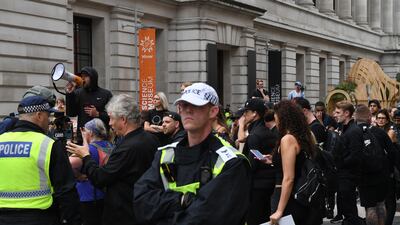Anti-vaccination protesters and police stand outside London's Science museum on Friday. Getty Images
