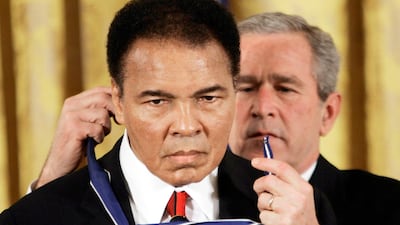 Donald Trump said he was seriously considering a pardon for Muhammad Ali, pictured here in November 2009 with President George Bush. He doesn't need one. (AP Photo/Evan Vucci)