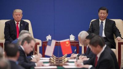 This 2017 photo shows US President Donald Trump and China's President Xi Jinping attending a business leaders event in Beijing. In the past few months, many Chinese companies have come under pressure to divest US operations. AFP