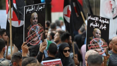 Former detainees of the pro-Israel South Lebanon Army militia hold posters depicting former SLA member Amer Fakhoury during a demonstration denouncing his return and entry outside the Justice Palace in Beirut. AFP