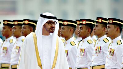 Abu Dhabi Crown Prince Mohamed Bin Zayed Al-Nahyan (C) inspects a guard of honour in Putrajaya on March 12, 2013. Sheikh Mohammed arrived for a visit to hold talks with the Malaysian leadership on bilateral and international issues. AFP PHOTO / MOHD RASFAN