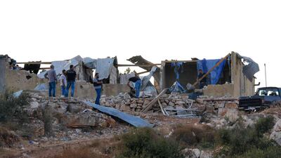 Members of Lebanon's Internal Security Forces inspect a damaged house where suspected ISIS members were hiding before a police raid. AFP