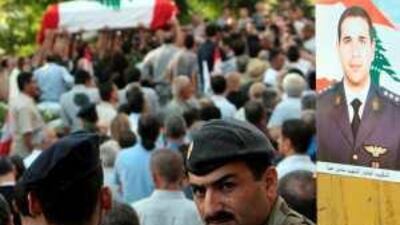 Lebanese officers carry the coffin of their colleague Samir Hanna during his funeral at his home village of Tanourine in August 2008.