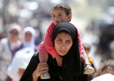 A woman and child leave Khan Younis in southern Gaza, following an Israeli eviction order. Reuters
