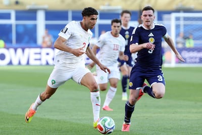 Morocco's Achraf Hakimi, left, in action against Scotland's Andy Robertson EPA