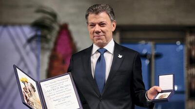 Nobel Peace Prize laureate Colombian President Juan Manuel Santos poses with the medal and diploma during the award ceremony of the Nobel Peace Prize for 2016. Haakon Mosvold Larsen / AFP